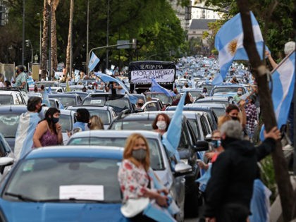 People take part in a protest against the government of Argentina's President Alberto Fernandez at Plaza de la Republica square in Buenos Aires on November 8, 2020, amid the recent new phase of social distancing against the spread of the COVID-19 coronavirus. - Thousands demonstrated against the government, summoned by …