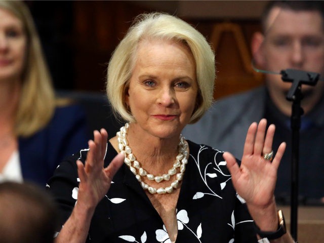 In this Jan. 13, 2020, file photo Cindy McCain, wife of former Arizona Sen. John McCain, waves to the crowd after being acknowledged by Arizona Republican Gov. Doug Ducey during his State of the State address on the opening day of the legislative session at the Capitol in Phoenix. Democratic …
