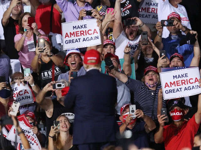 People cheer as U.S. President Donald Trump arrives to speak during his campaign event at Miami-Opa Locka Executive Airport on November 1, 2020 in Opa Locka, Florida. President Trump continues to campaign against Democratic presidential nominee Joe Biden leading up to the November 3rd Election Day. (Photo by Joe Raedle/Getty …