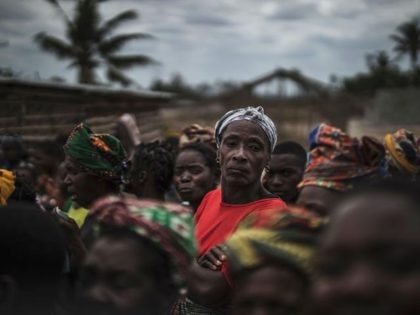 A villager looks on as residents gather for a distribution of utensils organised by the Catholic relief organisation CARITAS in the village of Muagamula, outside Macomia, northern Mozambique on August 24, 2019. - Pope Francis is scheduled to visit Mozambique, Madagascar and Mauritius in a pastoral visit from September 4th …