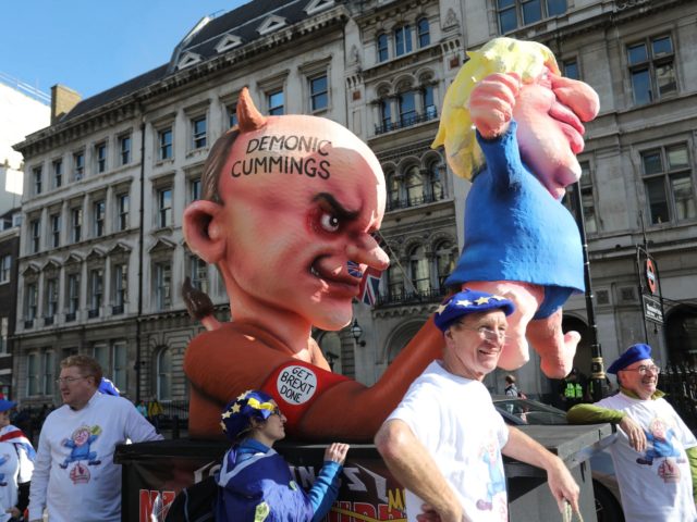 Activists from the People's Vote organisation calling for a second referendum on Brexit unveil an effigy depicting Britain's Prime Minister Boris Johnson as a puppet operated by his advisor Dominic Cummings in central London on October 19, 2019, ahead of a march and rally. - Thousands of people march to …