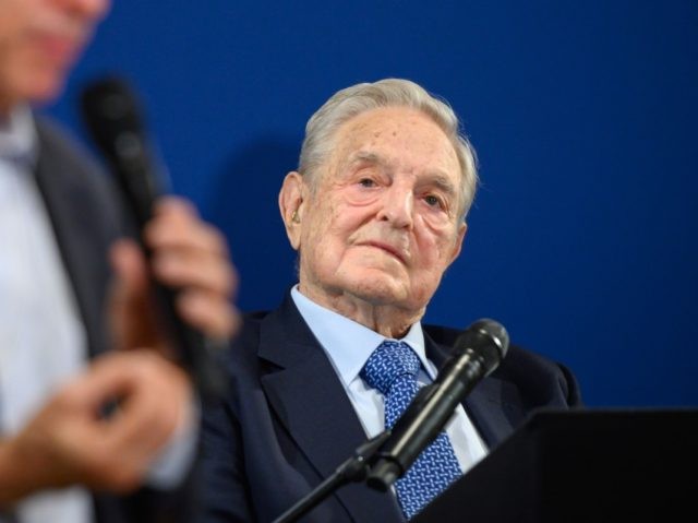 Hungarian-born US investor and philanthropist George Soros (R) listens to Human Rights Wat