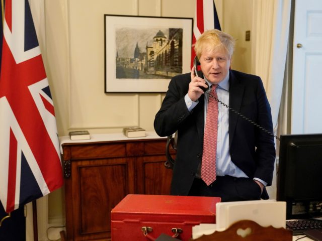 LONDON, ENGLAND - MARCH 25: Prime Minister Boris Johnson on the telephone to Queen Elizabeth II for her Weekly Audience during the coronavirus (COVID-19) pandemic at 10 Downing Street on March 25, 2020 in London, England. (Photo by Andrew Parsons-WPA Pool/Getty Images)