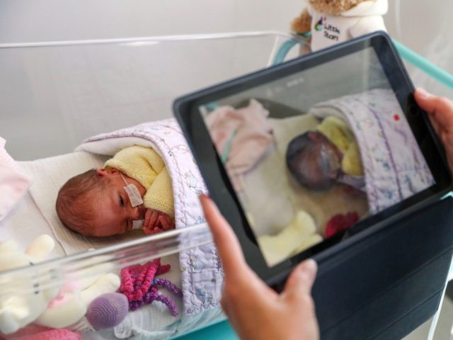 FRIMLEY, ENGLAND - MAY 22: Image released on May 27, A nurse makes a video of a newborn baby in the maternity ward at Frimley Park Hospital in Surrey to send to the parents as visiting hours are restricted because of COVID pandemic on May 22, 2020 in Frimley, United …