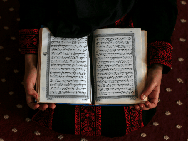 A Palestinian girl attends a Koran memorization class while respecting social distancing d