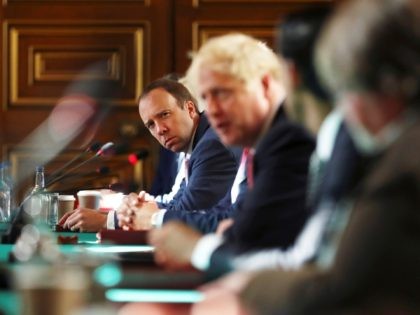 LONDON, ENGLAND - JULY 21: Health Secretary Matt Hancock looks on as Prime Minister Boris Johnson chairs a face-to-face meeting of his cabinet team of ministers, the first since mid-March, at the Foreign and Commonwealth Office (FCO) on July 21, 2020 in London, England. The meeting in the FCO will …