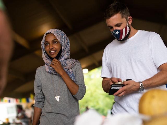 RICHFIELD, MN - AUGUST 08: Rep. Ilhan Omar (D-MN) (C) campaigns with her husband Tim Mynett (R) at the Richfield Farmers Market on August 8, 2020 in Richfield, Minnesota. Omar is hoping to retain her seat as the representative for Minnesota's 5th Congressional District in next week's primary election. (Photo …