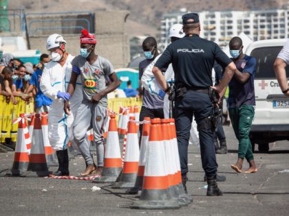 Migrants are helped upon their arrival at Puerto de Arguineguin harbour following their re