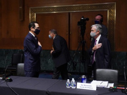 (L-R) US Secretary of the Treasury Steven Mnuchin greets Chairman of the Federal Reserve Jerome Powell before testifying during the Senate's Committee on Banking, Housing, and Urban Affairs hearing examining the quarterly CARES Act report to Congress on September 24, 2020, in Washington, DC. (Photo by Toni L. Sandys / …