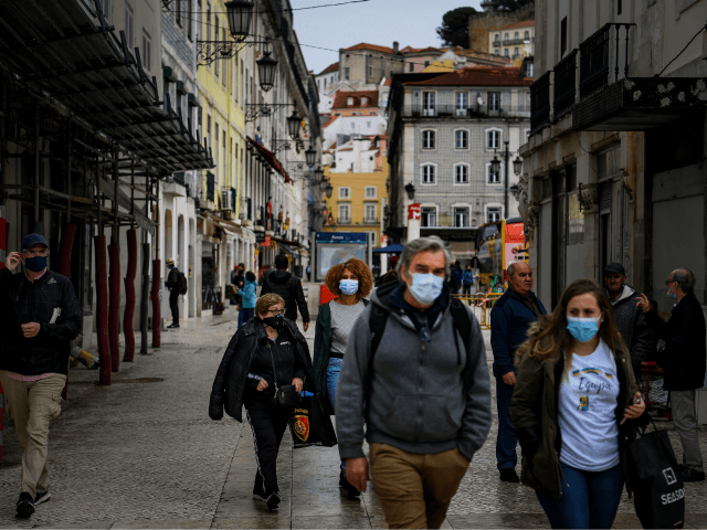 People wear face masks in downtown Lisbon on October 28, 2020. - The Portuguese support th