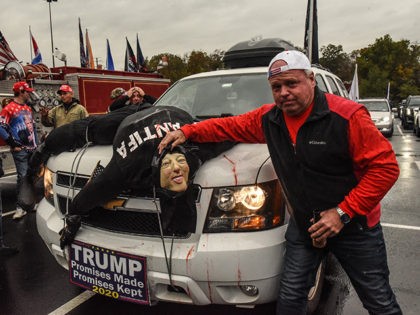 WEST NYACK, NY - NOVEMBER 01: A Trump supporter with an effigy of a dead Antifa person on his car attends a pro-Trump rally on November 1, 2020 in West Nyack, New York. With just two day left before the U.S. Presidential election, Trump supporters coordinated large caravans across the …