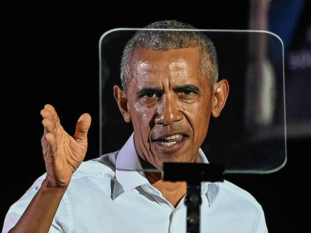 Former US President Barack Obama speaks at a drive-in rally as he campaigns for Democratic presiden