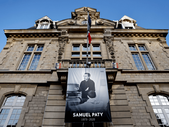 This picture taken on November 3, 2020 show a poster depicting French teacher Samuel Paty placed on the facade of the city hall in Conflans-Sainte-Honorine, 30kms northwest of Paris, on November 3, 2020, following the decapitation of the teacher on October 16. - France on November 2 honoured the teacher …