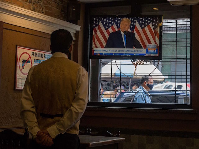 US President Donald Trump is displayed on a television screen at a restaurant in Caracas,