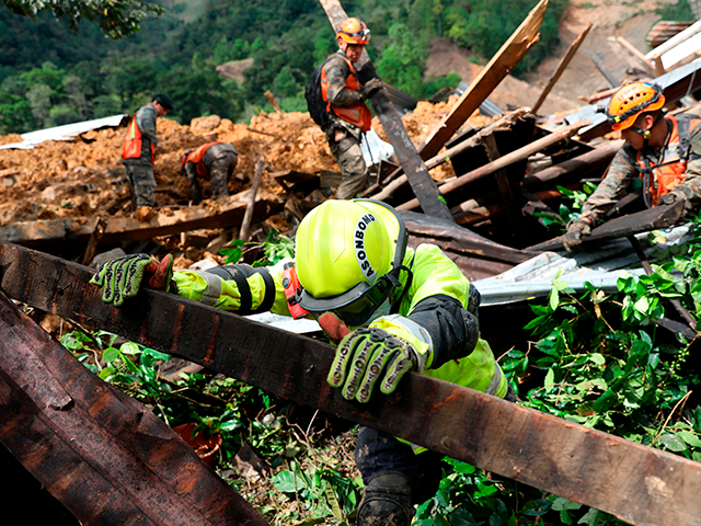 Rescue workers search for victims of a musdlide caused by the passage of Hurricane Eta in the village of Queja, in San Cristobal Verapaz, Guatemala on November 7, 2020. - About 150 people have died or remain unaccounted for in Guatemala due to mudslides caused by powerful storm Eta, which …