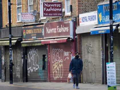 A man walks past closed shops in London on November 10, 2020. - Britain's unemployment rate has jumped to 4.8 percent as the coronavirus pandemic destroys a record number of UK jobs, official data showed Tuesday. (Photo by Tolga Akmen / AFP) (Photo by TOLGA AKMEN/AFP via Getty Images)