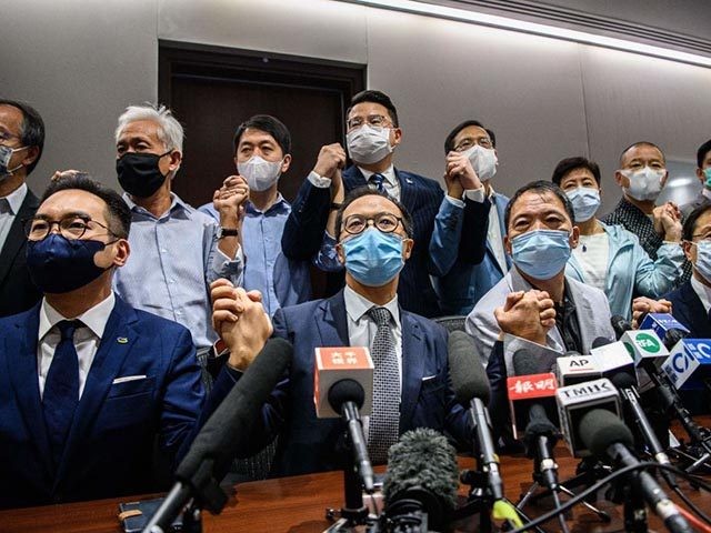 Pro-democracy lawmakers join hands at the start of a press conference in a Legislative Council office in Hong Kong on November 11, 2020. - Hong Kong's pro-democracy lawmakers said on November 11 they would all resign, after China gave the city the power to disqualify politicians deemed a threat to …