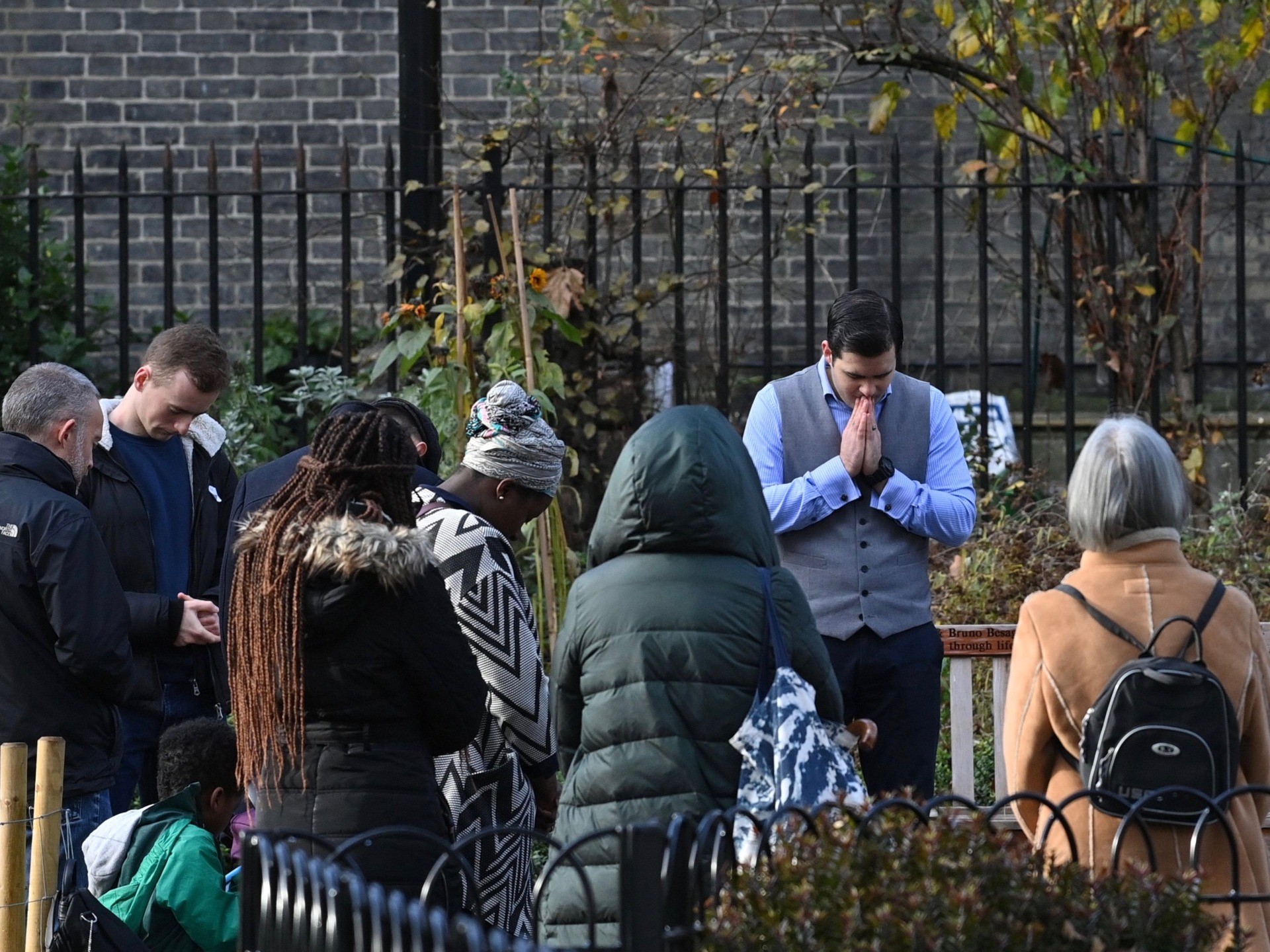 Pastor Regan King (C), of the Angel church in north London holds a service in near-by Myddelton Square Gardens on November 15, 2020, after coming to a agreement with the police to hold the service outside. - An evangelical church is defying lockdown restrictions to combat the spread of the novel coronavirus covid-19, by holding a public service on Sunday. (Photo by JUSTIN TALLIS / AFP) (Photo by JUSTIN TALLIS/AFP via Getty Images)