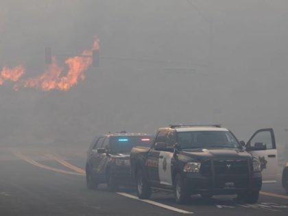 RENO, NV - NOVEMBER 17: Reno Police block road access while engulfed in wildfire smoke from the Pinehaven Fire on November 17, 2020 in Reno, Nevada. The Pinehaven Fire has burned at least 1,500 acres, destroyed multiple structures and is threatening hundreds more. (Photo by Trevor Bexon/Getty Images)