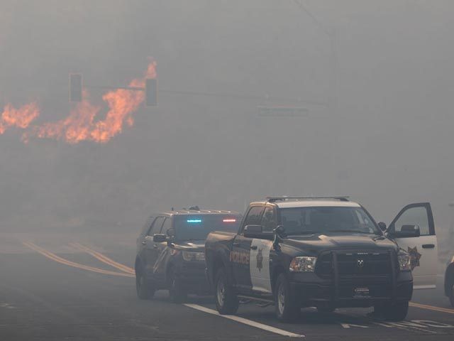 RENO, NV - NOVEMBER 17: Reno Police block road access while engulfed in wildfire smoke fro