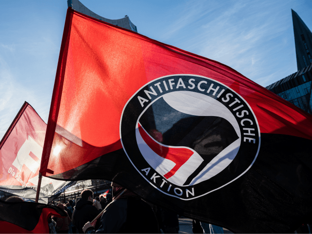 LEIPZIG, GERMANY - NOVEMBER 21: People are protesting prior a rally against coronavirus lockdown measures during the second wave of the pandemic on November 21, 2020 in Leipzig, Germany. The demonstration, which includes a range of protesters including neo-Nazis, hooligans, conspiracy theory activists and ordinary citizens, comes on the heels …