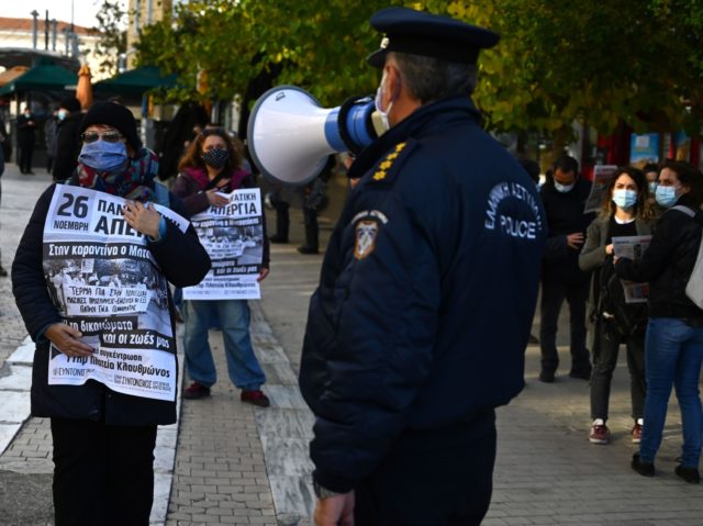 A woman holds a sign reading 'strike' during a general strike to protest draft l