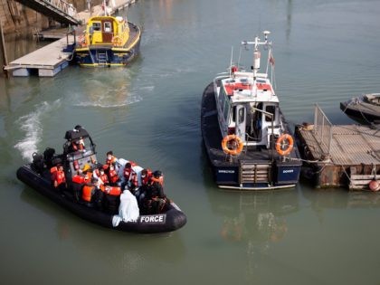 DOVER, ENGLAND - SEPTEMBER 22: Border Force officials unload migrants, that have been intercepted in the English Channel, in order to process them on September 22, 2020 in Dover, England. This summer has seen an increase in people making the journey in small crafts from France seeking asylum in U.K. …