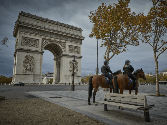 PARIS, FRANCE - OCTOBER 31: Mounted Police patrol around the Arc de Triomphe on the second day of national lockdown confinement as part of new increased security in the wake of recent terrorist attacks on October 31, 2020 in Paris, France. France has imposed another national lockdown for a minimum …