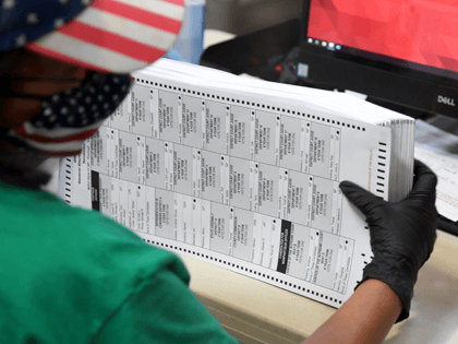 A Clark County election worker scans mail-in ballots at the Clark County Election Departme