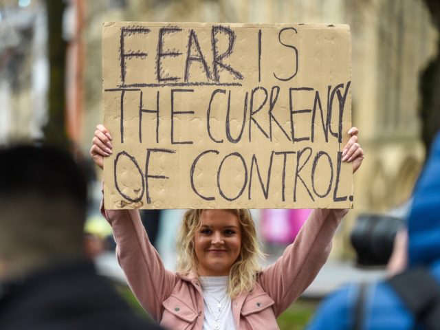 BRISTOL, ENGLAND - NOVEMBER 14: Protesters hold placards during the anti-lockdown protest on November 14, 2020 in Bristol, England. Police had warned protesters to cancel the march or face possible fines. Throughout the covid-19 pandemic, there have been recurring, if modest, protests across England against lockdown restrictions and other rules …
