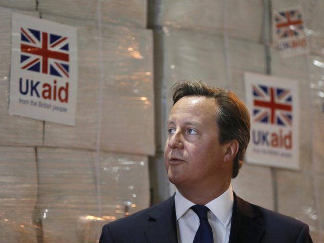 Britain's Prime Minister David Cameron visits a UK Aid Disaster Response Centre where humanitarian supplies are being collected to be airlifted to Iraq at Cotswold Airport near the village of Kemble, Gloucestershire, southern England on August 14, 2014. An international plan is under way to rescue civilians trapped by Islamic …