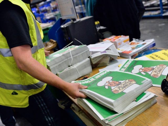 MARNE-LA-VALLEE, FRANCE - JANUARY 14: A worker prepares the new edition of Charlie Hebdo f