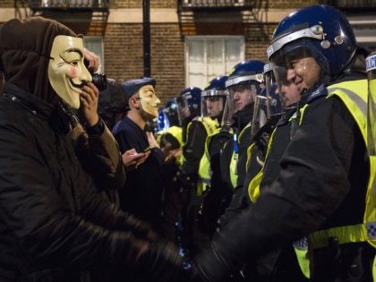 Anti-capitalist protesters wearing Guy Fawkes masks clash with British police during the "Million Masks March", organised by the group Anonymous, near the Houses of Parliament in central London on November 5, 2015. The protest was held on the night of Britain's Guy Fawkes Night, and many of the marchers wore …