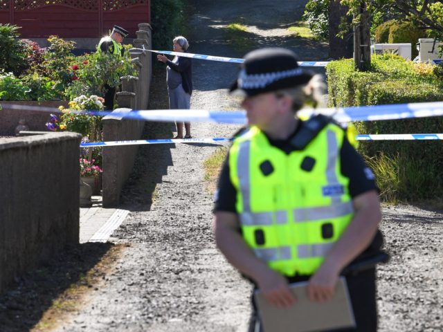 ROTHESAY, ISLE OF BUTE, SCOTLAND - JULY 02: Police stand next to a cordoned of house on Ardbeg Road, near to where the body of a six year old girl was found on July 2, 2018 in Bute, Scotland. The body was discovered this morning in the grounds of a …