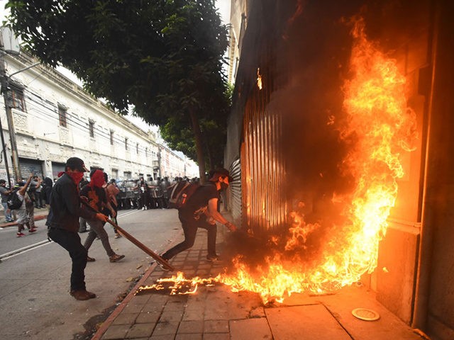 TOPSHOT - Demonstrators set on fire part of the Congress building during a protest demandi
