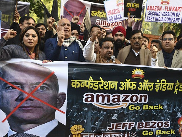 Traders hold placards during a demonstration demanding the closure of online shopping platforms Amazon and Flipkart, in New Delhi on January 15, 2020. - Bezos, whose worth has been estimated at more than $110 billion, is officially in India for a meeting of business leaders in New Delhi. (Photo by …