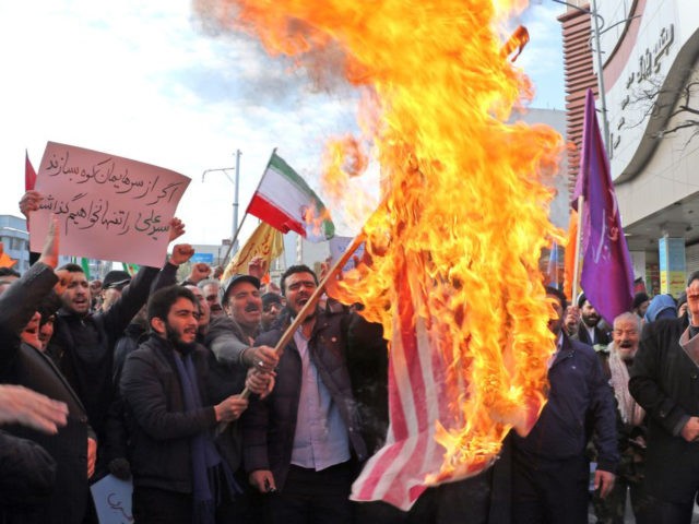 Iranian men burn a US flag during a protest in support of the Islamic republic's government and supreme leader, Ayatollah Ali Khamenei, in the northwestern city of Ardabil on November 20, 2019, as President Hassan Rouhani said the country's people had defeated an "enemy conspiracy" behind a wave of violent …