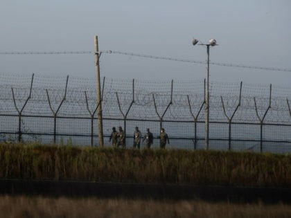 South Korean soldiers walk along a fence of the Demilitarized Zone (DMZ) separating North and South Korea, on the South Korean island of Gyodong on October 6, 2020. (Photo by Ed JONES / AFP) (Photo by ED JONES/AFP via Getty Images)