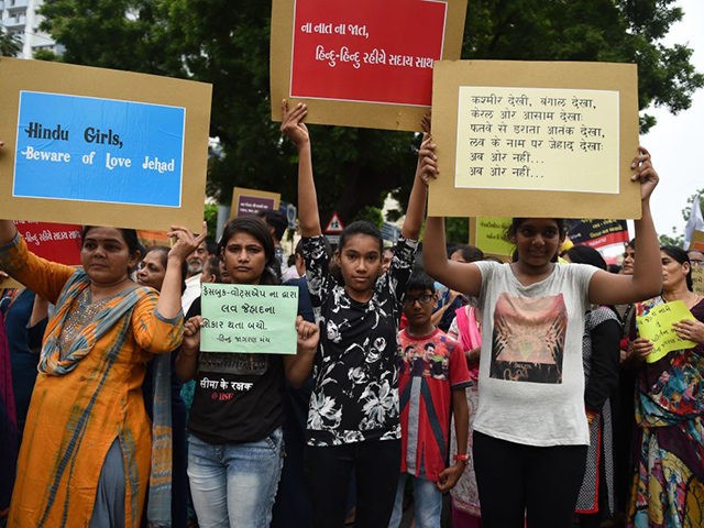 Indian Hindus hold placards as they take part in a rally against 'Love Jihad', in Ahmedabad on July 22, 2018. - 'Love Jihad' is a term used to describe alleged campaigns under which Muslim men target women belonging to non-Muslim communities for conversion to Islam by feigning love. (Photo by …