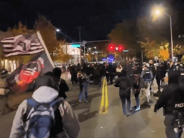 Marchers take the streets of a Portland suburb. (Twitter Video Screenshot)