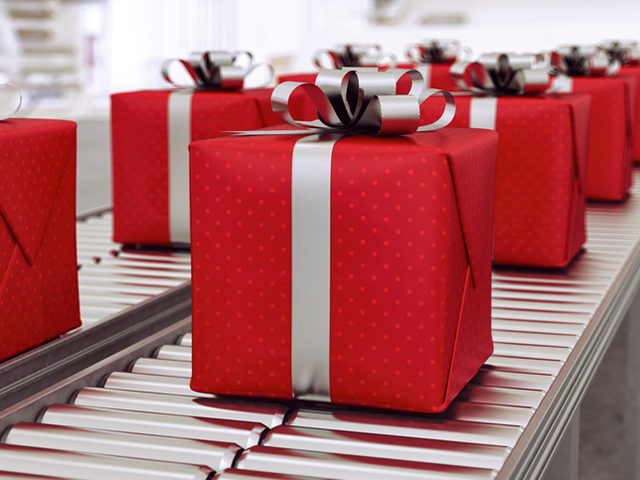 Red gift boxes on conveyor belt in time for christmas