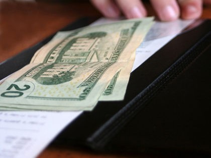 Money and receipt being placed on the payment binder for payment of a meal.