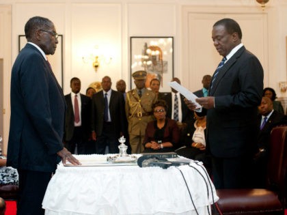 Zimbabwe's newly appointed vice president Emmerson Mnangagwa (R) takes the oath of office before President Robert Mugabe (L) at the State House in Harare on December 12, 2014. Zimbabwe's Justice Minister Emmerson Mnangagwa, a long-time ally of Mugabe, was sworn in as vice president, putting him firmly in line to …