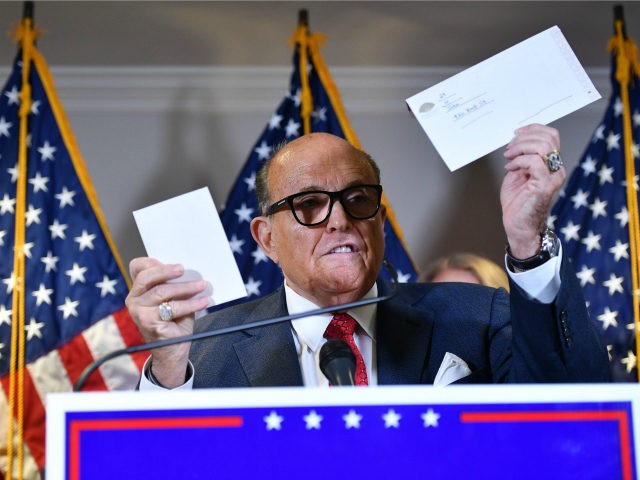 Trump's personal lawyer Rudy Giuliani holds a ballot envelope as he speaks during a press conference at the Republican National Committee headquarters in Washington, DC, on November 19, 2020. (Photo by MANDEL NGAN / AFP) (Photo by MANDEL NGAN/AFP via Getty Images)