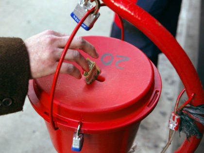 A donation is made into the kettle of Salvation Army bell ringer Robert Walker outside a store on the Magnificent Mile November 21, 2003 in Chicago. Funds raised through the Chicagoland bell ringing campaign will be used year-round to help feed the hungry, shelter the homeless, give help to the …