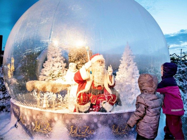 A Santa is seen in a coronavirus-safe plastic bubble at the Zoo in Aalborg on November 13, 2020. (Photo by Henning Bagger / Ritzau Scanpix / AFP) / Denmark OUT (Photo by HENNING BAGGER/Ritzau Scanpix/AFP via Getty Images)