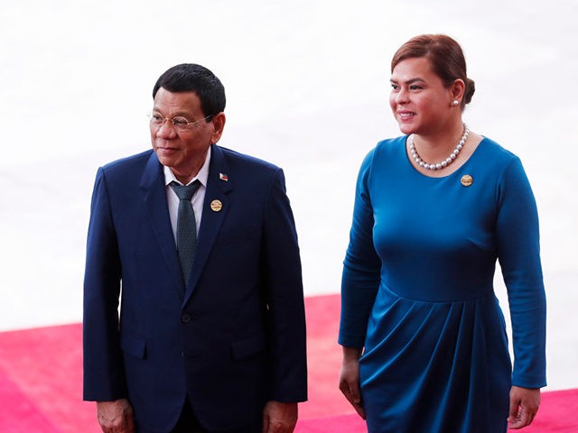 Philippine President Rodrigo Duterte (L) and his daughter Sara Duterte arrive for the opening of the Boao Forum for Asia (BFA) Annual Conference 2018 in Boao, south China's Hainan province on April 10, 2018. The BFA annual conference 2018 takes place between April 8-11. / AFP PHOTO / - / …