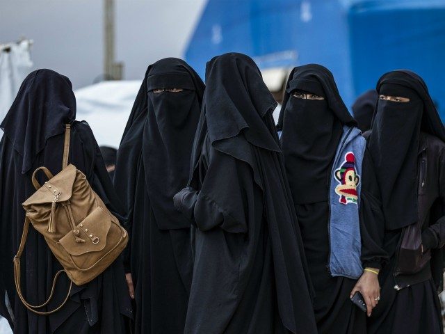 Syrian women get ready to leave the Kurdish-run al-Hol camp holding relatives of alleged Islamic State (IS) group fighters, in the al-Hasakeh governorate in northeastern Syria, on November 16, 2020. - A Kurdish official in charge of the region's camps, said 515 people from 120 families were returning to areas …