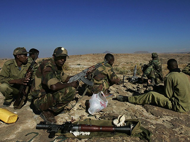 ZALA ANBESA, ETHIOPIA: Ethiopian soldiers on duty at one of the observation posts that face the Temporary Security Zone and the Eritrean border in the northern town of Zala Anbessa in the Tigray region of Ethiopia, clean their weapons 19 November 2005. AFP PHOTO/MARCO LONGARI (Photo credit should read MARCO …