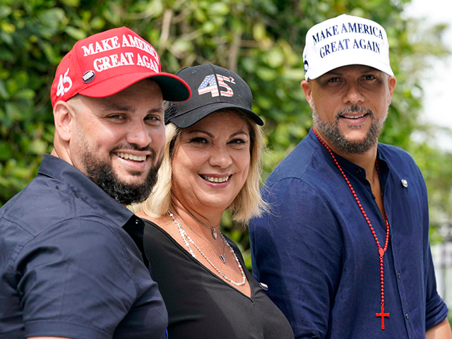 Tirso Luis, left, Ana Paez, and German Pinelli, right, members of the band Los 3 de la Habana, pose for a photograph, Thursday, Oct. 22, 2020, in Miami. The Cuban artists, who sought asylum in the U.S., have composed a salsa song in support of President Donald Trump, which is …
